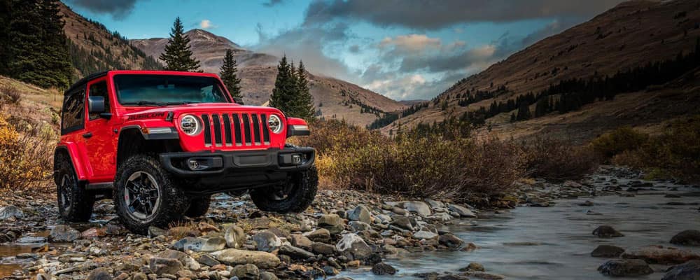 Jeep Wrangler driving through the landscape perfect for camping