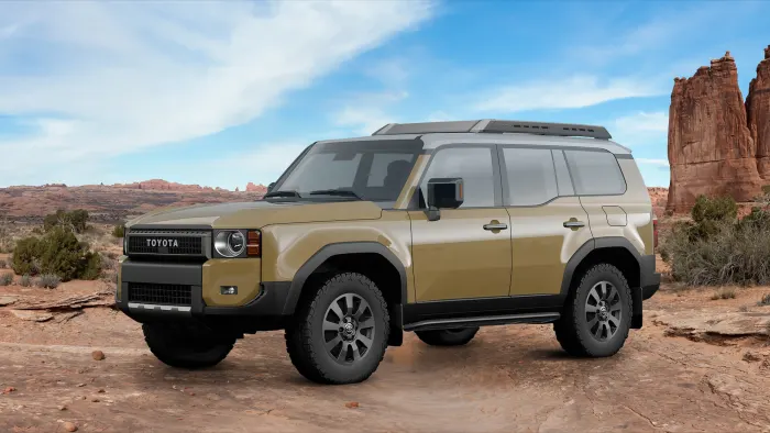 2024 Toyota Land Cruiser driving through rugged terrain with full-time four-wheel drive