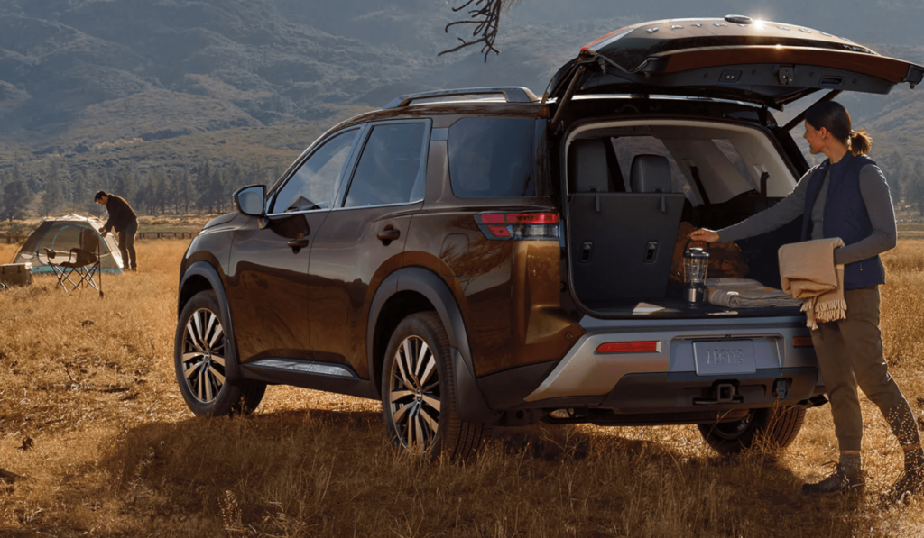 Nissan Pathfinder parked in wilderness showing it's camping capabilities."