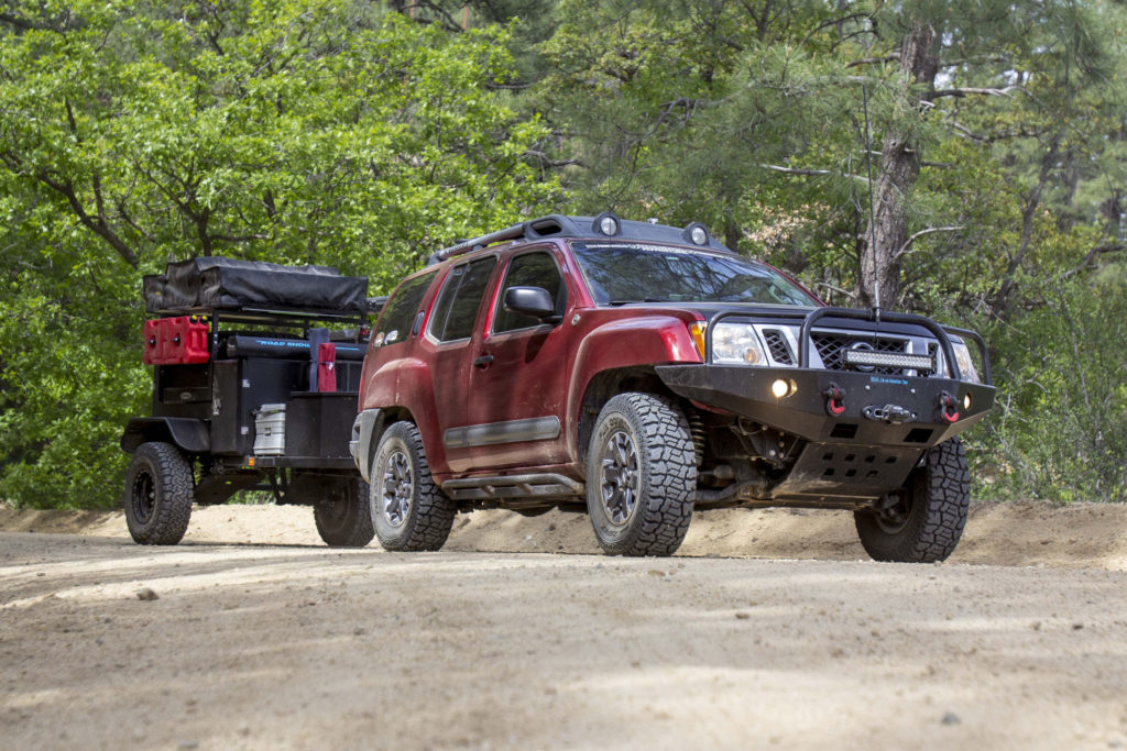 Nissan Xterra on a trail, highlighting its off-road features for camping.