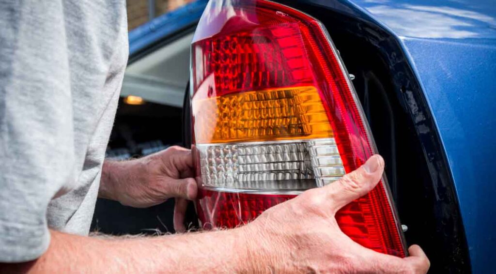 tail light cover on a Honda CR-V being removed and replaced.