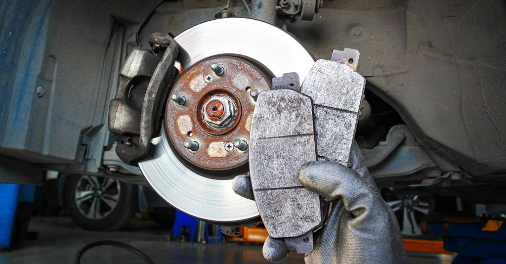 How to Change Brake Pads Without a Mechanic – Hands Holding New Brake Pads