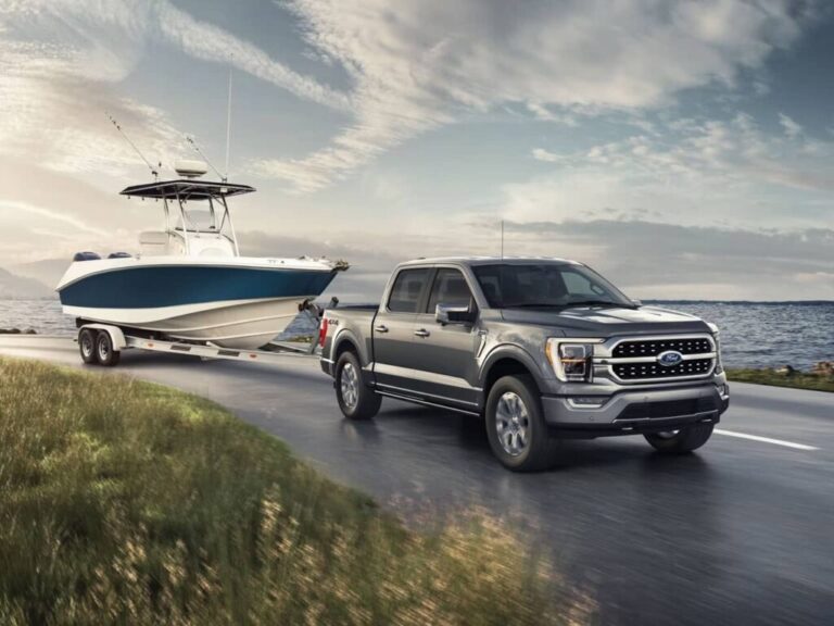 Cover image of truck towing boat. Showcasing the best trucks for towing boats.