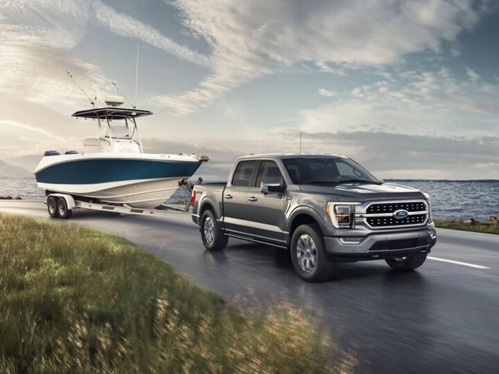 Cover image of truck towing boat. Showcasing the best trucks for towing boats.