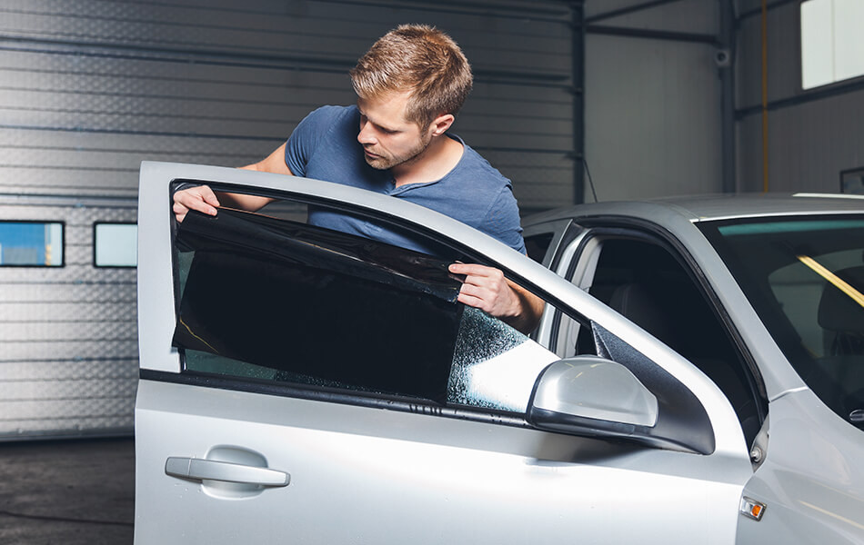 Car with tinted windows to minimize sunlight glare on the windshield.